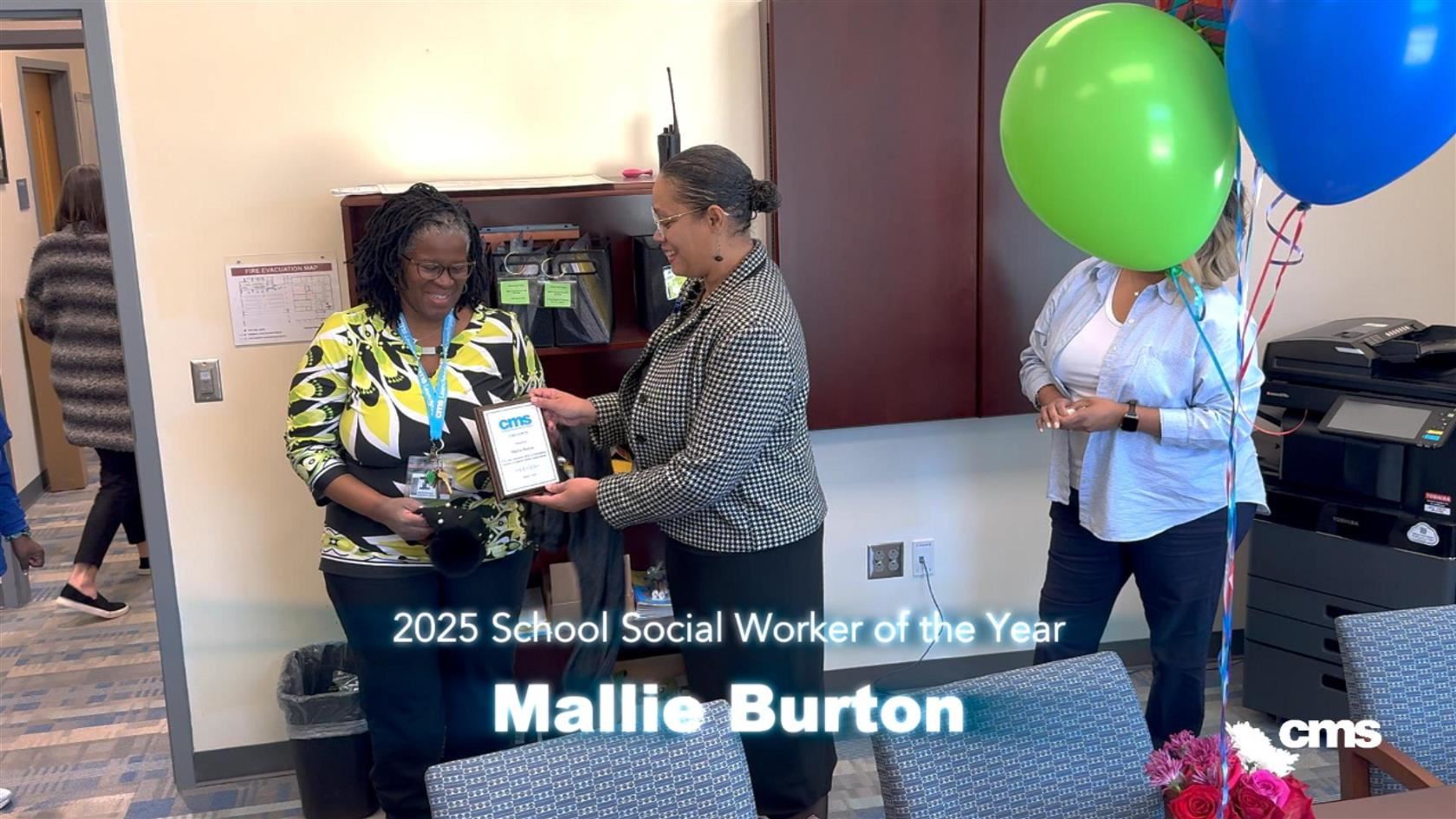 Mallie Burton, school social worker, was surprised with a plaque.